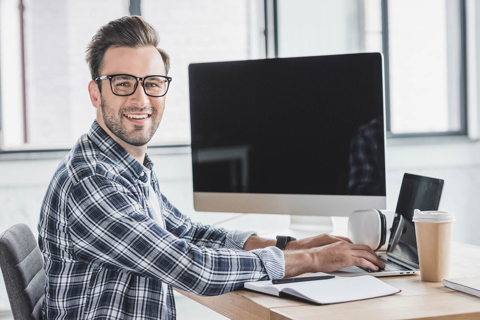 man smiling from computer