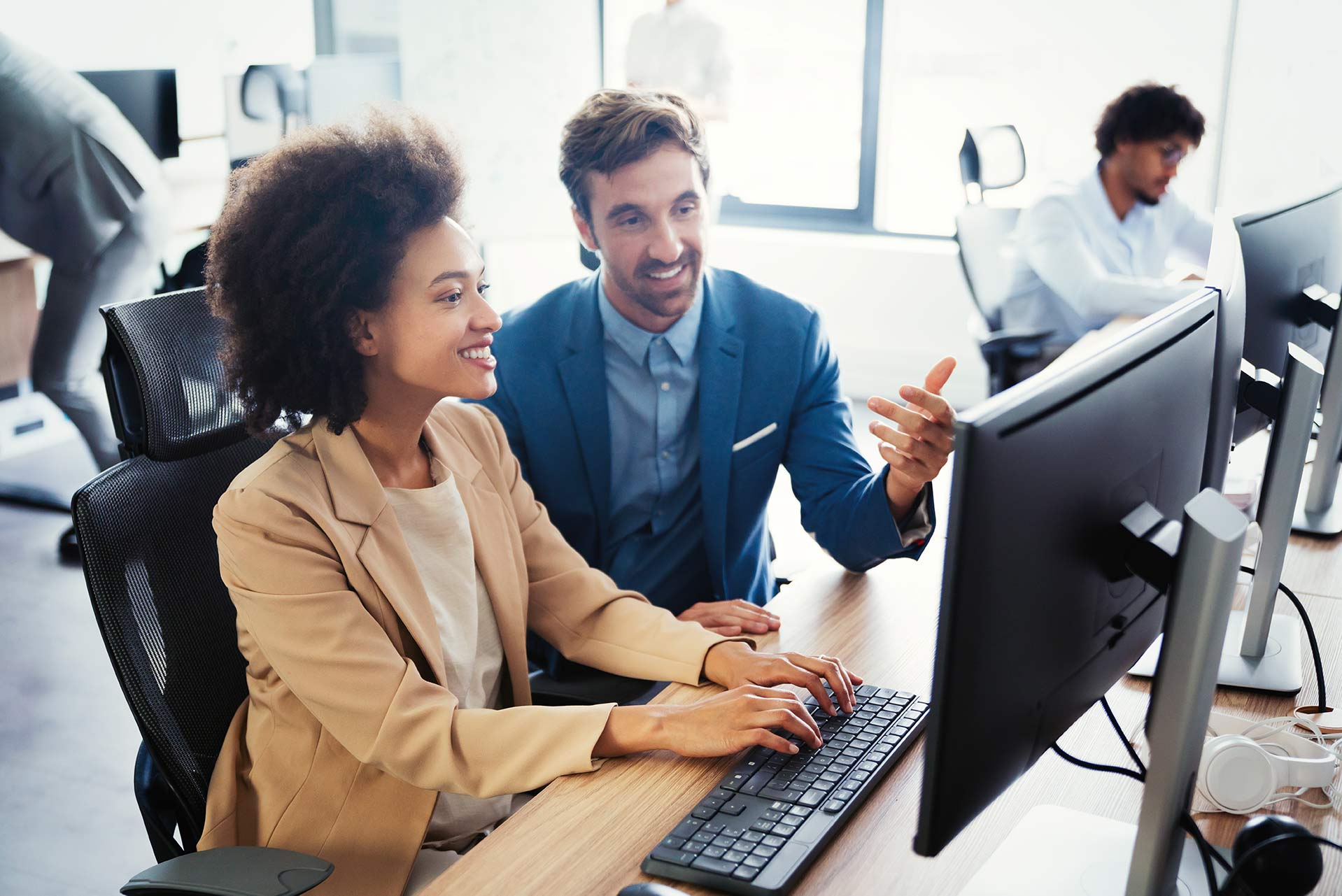 man and woman working on IT solutions