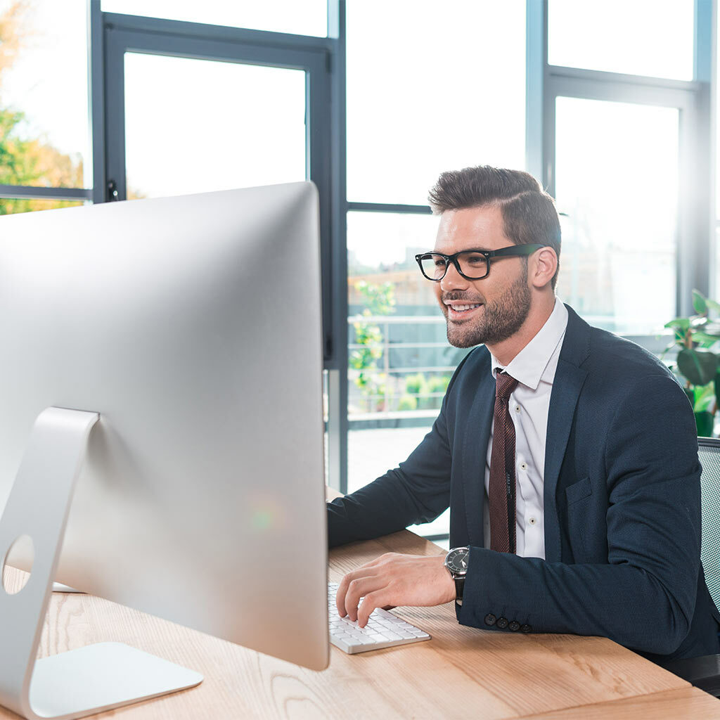 man smiling working from computer